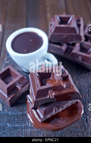 chocolate in cup and on the wooden table Stock Photo