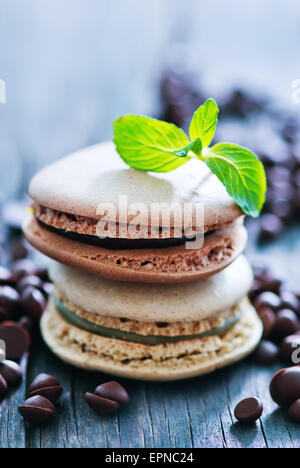 chocolate macaroons and mint leaf on a table Stock Photo