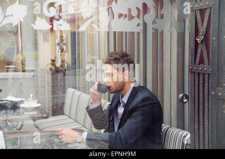 young attractive businessman drinking espresso coffee in the city cafe during lunch time, business concept Stock Photo