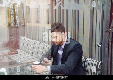young attractive businessman drinking espresso coffee in the city cafe during lunch time, business concept Stock Photo