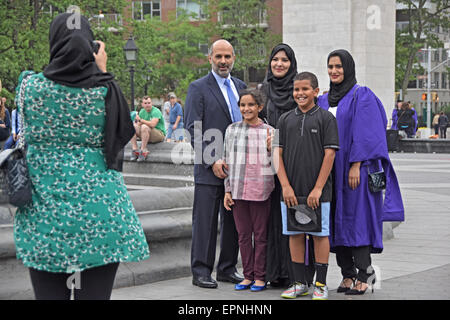 A Muslim family posing for a photo after a daughter's graduation from NYU. In Washington Square Park in New York City Stock Photo