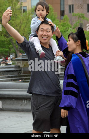 An Asian family taking a selfie after the mother's graduation from NYU. In Washington Square Park in New York City Stock Photo