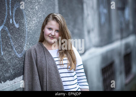 Portrait of cute teen girl standing on the street. Stock Photo