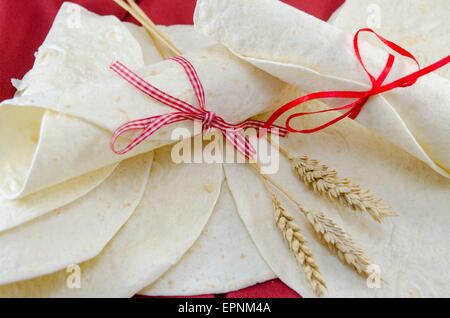 Empty tortillas tied with a ribbon on a table Stock Photo