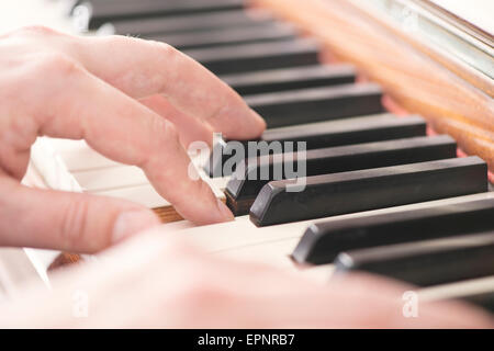 Close up of hands of man playing the piano Stock Photo