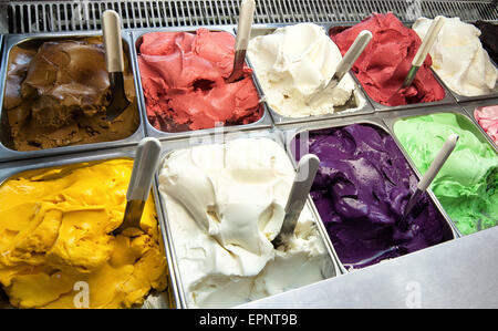 Colorful display of an assortment of freshly made different fruity flavored Italian ice cream in the window of an ice cream par Stock Photo
