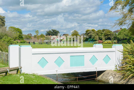 Footbridge across a stream with a park behind it at Mewsbrook Park, Littlehampton, West Sussex, England, UK. Stock Photo