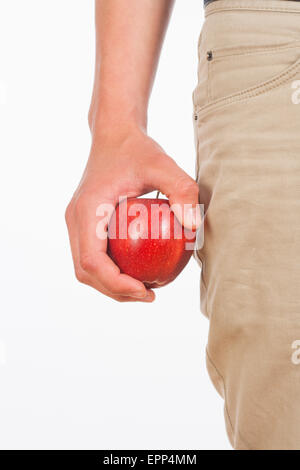 Hand Holding Red Apple Against White Background Stock Photo