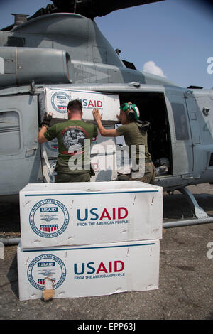 Relief supplies for Nepali earthquake victims are loaded onto a U.S. Marine Corps UH-1Y Venom helicopter May 19, 2015 in Kathmandu, Nepal. Nepal is recovering from a 7.8 magnitude earthquake that struck the kingdom, April 25 and a 7.3 earthquake on May 12. Stock Photo