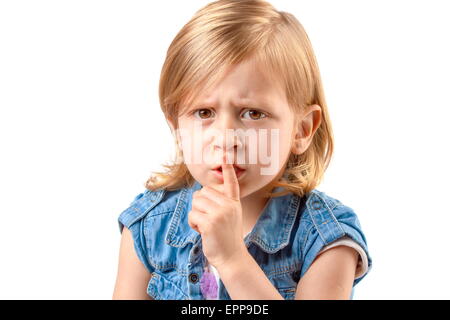 Portrait of little girl making hush sign Stock Photo