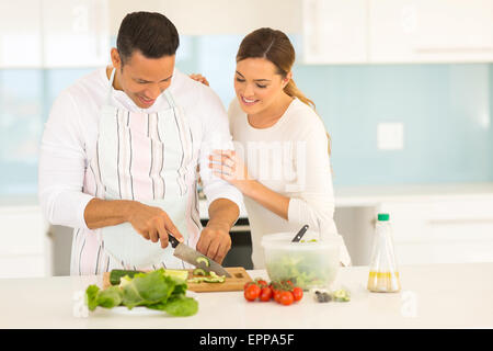 beautiful couple cooking together in home kitchen Stock Photo