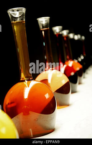 Different colors and types of wine in special big bottles on a black background Stock Photo