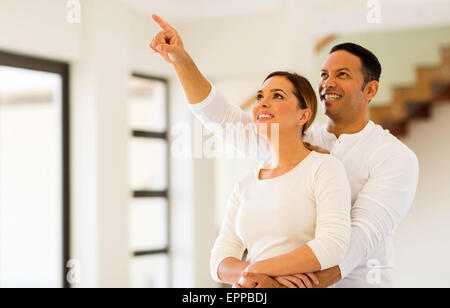 cheerful couple looking round their new house Stock Photo
