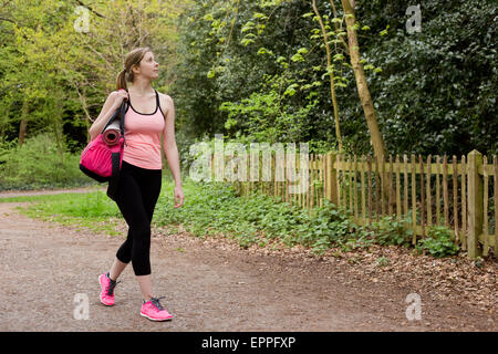 young woman walking home from the gym Stock Photo