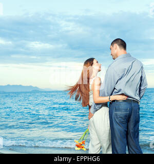 Young beautiful couple staying near the ocean Stock Photo