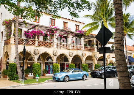 Florida Palm Beach Worth Avenue luxury shopping street road colonial style arcade colonnade fancy cars Bentley BMW Stock Photo