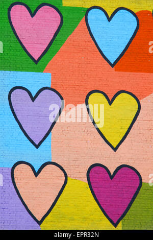 Colorful graffiti spray painted funny hearts on the decorated  b Stock Photo