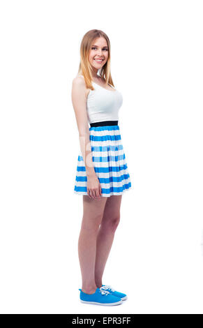 Full length portrait of a happy casual woman in dress standing isolated on a white background. Looking at camera Stock Photo