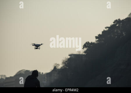 Silhouette of man flying drone over cliffs at the sunset Stock Photo