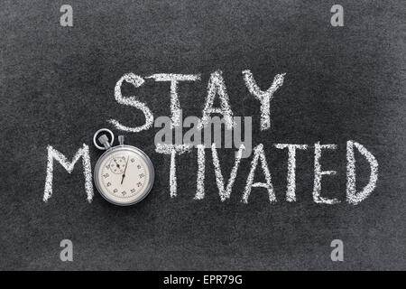 stay motivated phrase handwritten on chalkboard with vintage precise stopwatch used instead of O Stock Photo