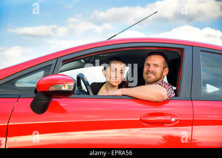 Couple in a red car Stock Photo