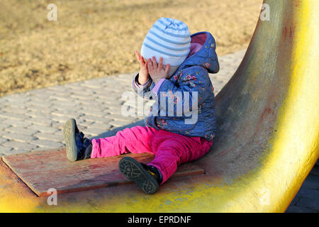 Little crying girl in park Stock Photo