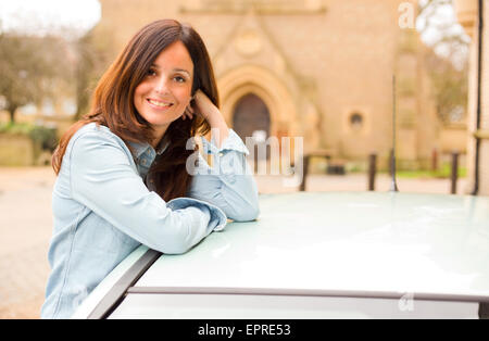 happy girl leaning out of car window. Stock Photo