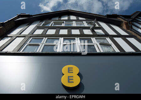 logo of an ee mobile phone shop, in new malden, surrey, england, below half timbered building facade Stock Photo