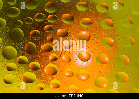 Group of drops on green and orange background Stock Photo