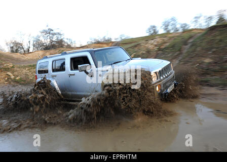 Hummer H3 driving off road through deep muddy water Stock Photo