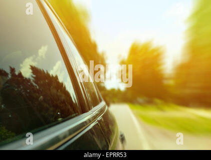 Car driving fast through forest road - Speed concept Stock Photo