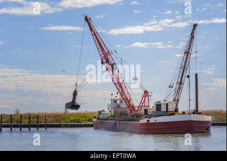 small dredge the marina, which is cleaning a navigation channel Stock Photo