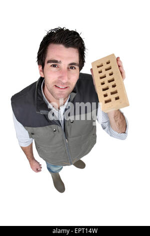 craftsman holding a brick Stock Photo