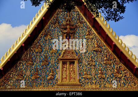 Bangkok, Thailand:  Ubosot sanctuary hall tympanum decorated with gilded bas relief Aponsi figures at Wat Chanasongkhram Stock Photo