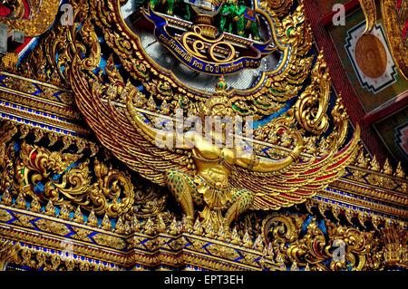 Bangkok, Thailand:  A large gilded Phoenix decorates the Ubosot sanctuary hall tympanum at Wat Hua Lamphong   * Stock Photo