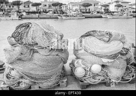 Fishing nets, fishing boats in the background Stock Photo