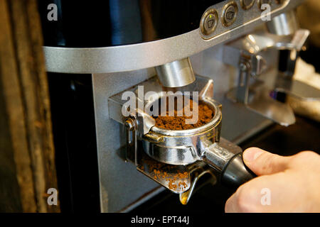 Automated Coffee Grinder Filling Portafilter Basket in Coffee Shop Stock Photo