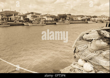 Fishing nets, fishing boats in the background.Vintage Stock Photo
