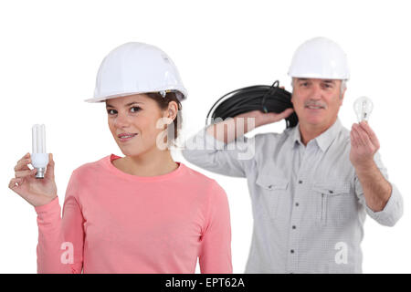 craftsman and craftswoman holding a bulb Stock Photo