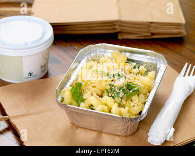 Gourmet Mac and Cheese Takeout with Plastic Fork and Soup and Brown Paper Bags Stock Photo