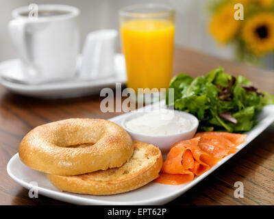 Smoked Salmon, Cream Cheese and Bagel with side of Mixed Greens Salad, Orange Juice and Coffee Stock Photo