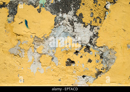 Rustic Background Texture | GRANADA, Nicaragua — Crumbling ochre plaster and exposed masonry form a weathered wall texture typical of Granada's aging colonial buildings. Such surfaces reveal the layered construction of lime plaster over rubble masonry, a method common to Spanish colonial architecture across Central America and still visible on many structures in this centuries-old lakeside city. Stock Photo