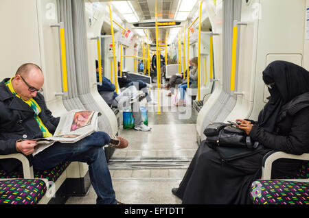 A woman in a burqa  on the London Overground in Britain Stock Photo
