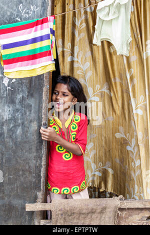 Mumbai India,Dharavi,Shahu Nagar Road,slum,low income,poor,poverty,girl girls,youngster,female kids children home,window,calling,India150228093 Stock Photo