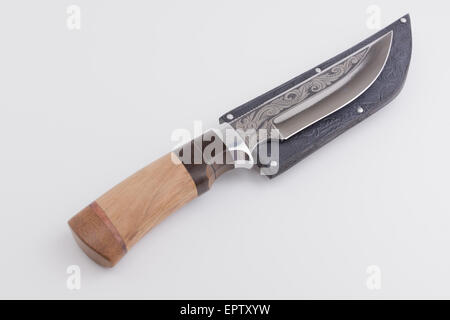 the hunting knife with an original ornament lies on a white background Stock Photo