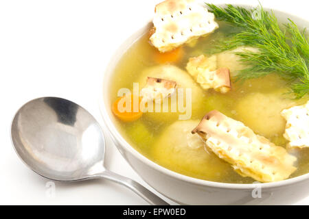 Delicious Matzoh ball soup with crackers wine and dill Stock Photo