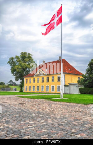 The Commander's House with Danish flag (Dannebrog) in Kastellet, Copenhagen, Denmark. Stock Photo