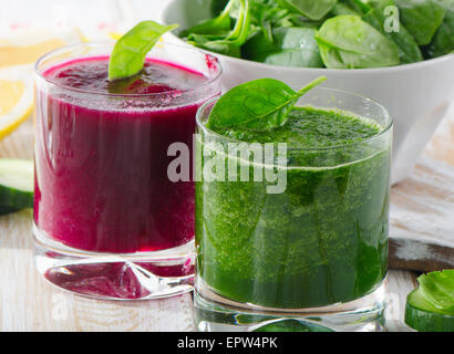 Glasses of Freshly Squeezed Vegetable Juices on wooden table. Stock Photo