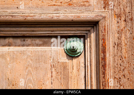 abstract   rusty brass brown knocker in a  door curch  closed wood lombardy italy  varese lonate pozzolo Stock Photo