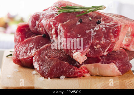 Raw beef t-bone steak on  cutting board. Stock Photo